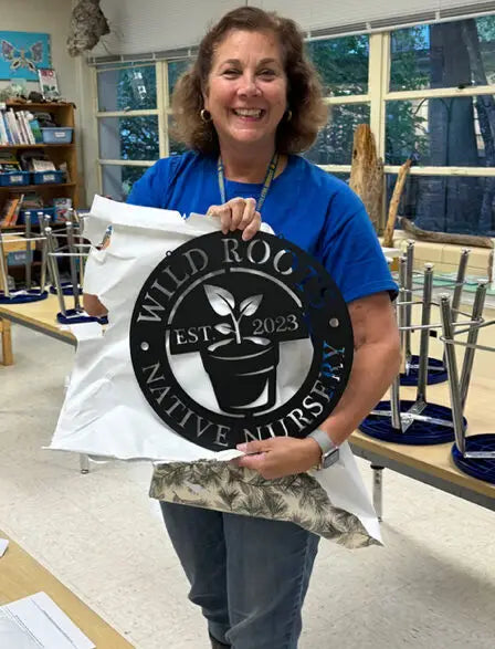 Stephanie unveiling the Wild Roots Native Nursery logo